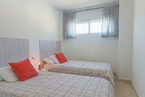a bedroom with two beds and a window at 099 - Parque y playa 007 - comfortHOLIDAYS in Santa Pola