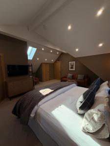 a bedroom with a large bed in a attic at The Stables Luxury B&B in Bury +15 photos