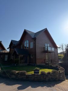 a large brown house with a stone circle at The Stables Luxury B&B in Bury