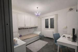 a bedroom with a bed with a chandelier at Acquamarina Luxury House in Budoni