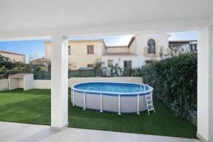 a pool in the backyard of a house at Acquamarina Luxury House in Budoni