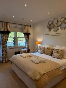 a bedroom with a large bed and a window at The Stables Luxury B&B in Bury