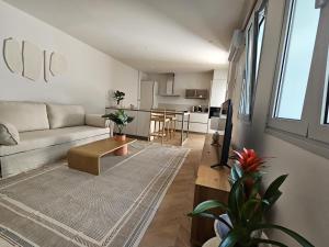 a living room with a couch and a table at Apartamentos Boutique Casco Histórico in Las Lagunas