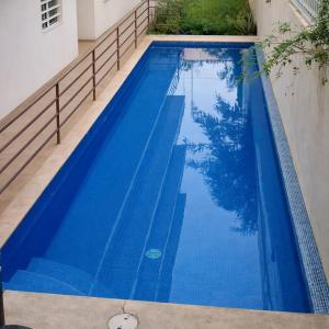 a swimming pool with blue water in a house at Condo Sunset in Cabo San Lucas