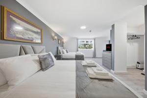a living room with a white couch and a tv at The Greyhound Hotel in Leigh +46 photos