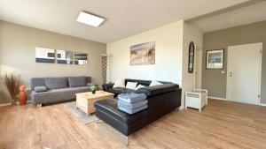a living room with a couch and a table at Ferienwohnung Reuscher, Trier-Newel in Newel