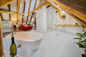 a bathroom with a white tub in a room at Hotel Svambersky dum in Český Krumlov +100 photos