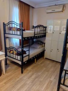 a room with two bunk beds and two lockers at Theodora Hostel in Istanbul