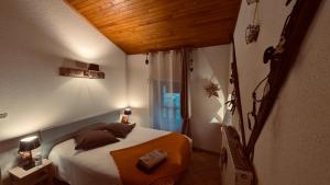 a small bedroom with a bed and a window at CHAMBRES D'HOTES L'ANTONIN in Saint-Antoine