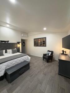 a large bedroom with a bed and a chair at Blue Cow Guest Farm in Cornville