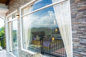 a large window with a view of a mountain view at MulBerry Villa in Kandy