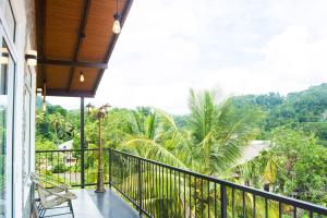 a balcony of a house with a view of the jungle at MulBerry Villa in Kandy