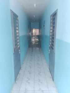 an empty hallway with two doors and a tile floor at Chambre et apparts meublés, Yaoundé - FOKOU EMANA in Yaoundé