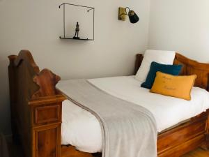 a bedroom with a bed with a mirror on the wall at Entre terre et mer in Ploemeur