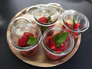 a plate with four glasses of strawberries on a table at Entre terre et mer in Ploemeur