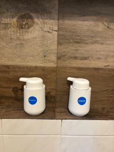 two white containers sitting next to each other on a wall at KC Suites in Comitán