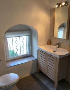 a bathroom with a sink and a window at Large period house with panoramic view in Canari +83 photos