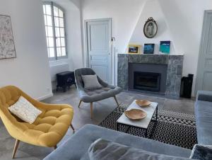 a living room with a couch and a fireplace at Large period house with panoramic view in Canari
