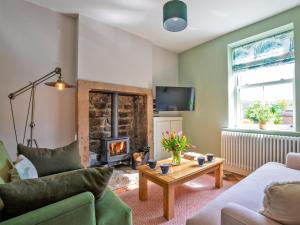a living room with a couch and a fireplace at 2 Bed in Bakewell oc-90406 in Bakewell