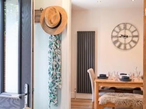 a dining room with a table and a hat on the wall at 2 Bed in Bakewell oc-90406 in Bakewell