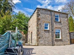 an old stone house with a blue fence at 2 Bed in Bakewell oc-90406 in Bakewell