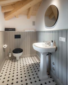 a bathroom with a sink and a toilet at The Castelletto - Boutique Hotel in Montebelluna +19 photos