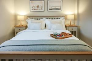 a bedroom with a bed with a tray of fruit on it at 2 Bed in St Helens oc-76608 in Brading