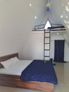 a bedroom with a bunk bed and a ladder at Mung Kham Stays in Jorhat