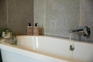 a bath tub with water coming out of a faucet at 1 Bed in Richmond oc-93264 in Richmond +34 photos