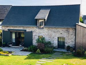 a brick house with a black roof at Entre terre et mer in Ploemeur