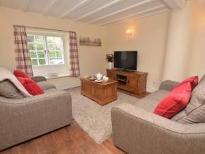 a living room with two couches and a television at 1 Bed in Sherborne oc-51018 in Bradford Abbas
