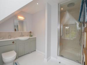 a bathroom with a shower and a toilet and a sink at 1 Bed in Sherborne oc-51018 in Bradford Abbas +11 photos