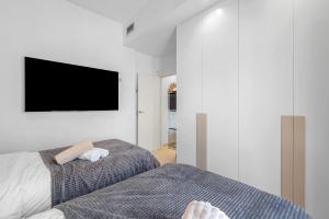 a bedroom with a bed and a tv on the wall at Villa Sol in Orihuela Costa +31 photos