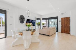 a living room with a table and chairs and a couch at Villa Sol in Orihuela Costa