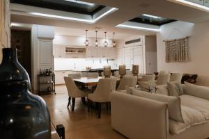 a living room with a couch and a table and chairs at Beach House Costa Yucatan by Trobbu Collection in Xtampú