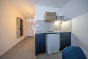 a kitchen with a sink and a counter top at City Résidence Nancy in Nancy +32 photos