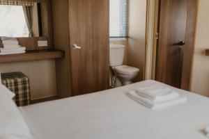 a small bathroom with a toilet and a mirror at Upper Cliff 2 in Easton