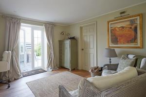 a living room with a white couch and a window at Rockstone Cottage in Freshwater +40 photos