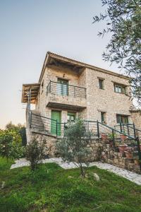 a large stone building with a staircase in front of it at GAIA - Boutique Retreat in Marathopoli