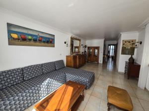 a living room with a couch and a table at Maison classée 3étoiles proche plage in Mauguio
