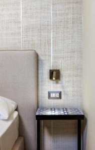 a nightstand with a clock on it next to a bed at Primo Piano Rooms in Aversa