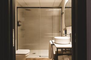 a bathroom with a shower with a toilet and a sink at Honest Granada Apartments in Granada