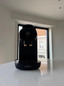 a black object sitting on the floor in a room at The Corner-MARGO in Beernem
