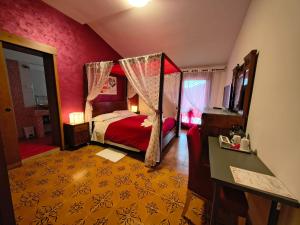 a bedroom with a bed with a canopy at B&B Nonna Assunta in Collegiove