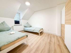 a bedroom with two beds and a window at Emmas FEWO in Bremen