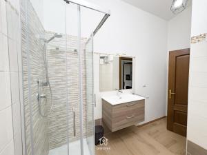 a bathroom with a shower and a sink at Residenza Centrale in Villasimius +39 photos