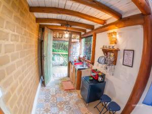 a small kitchen with a counter and chairs in a room at Pousada Villa Cachoeira in Carrancas +70 photos