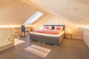 a bedroom with a bed in a attic at Tiny Barrhorn in Grächen +40 photos