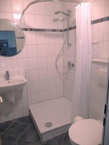 a bathroom with a shower and a toilet and a sink at FW Knütel Nr 59 in Burgtiefe auf Fehmarn 