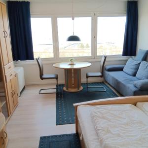 a living room with a bed and a table and a couch at FW Knütel Nr 59 in Burgtiefe auf Fehmarn 
